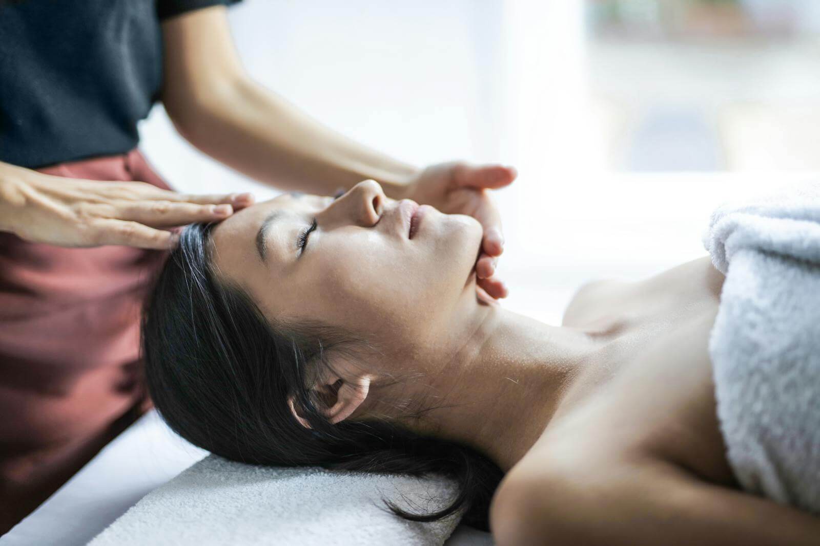 Selective Focus Photo of Woman Getting a Head Massage