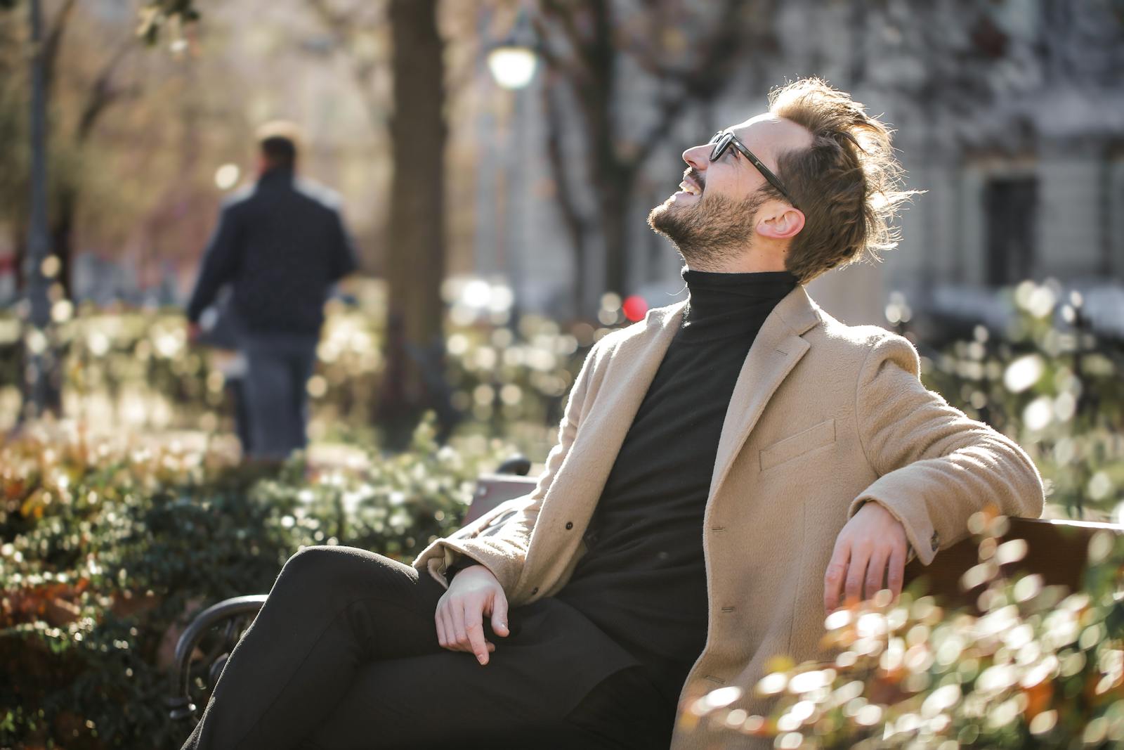 A Man sitting on a Metal Bench