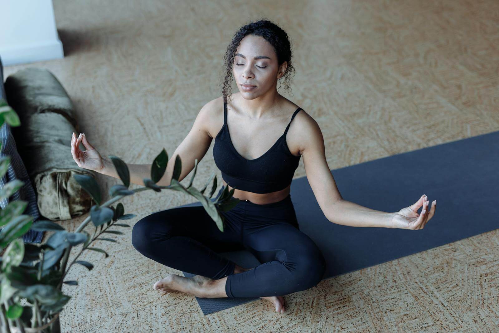 A Woman Wearing Black Active Wear Meditating